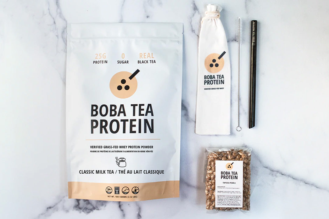 Boba Tea Protein pouch with straw set and tapioca pearls arranged on a marble surface.