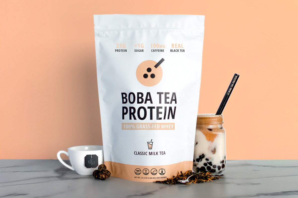 Boba Tea Protein package with a glass of bubble tea on a marble surface.