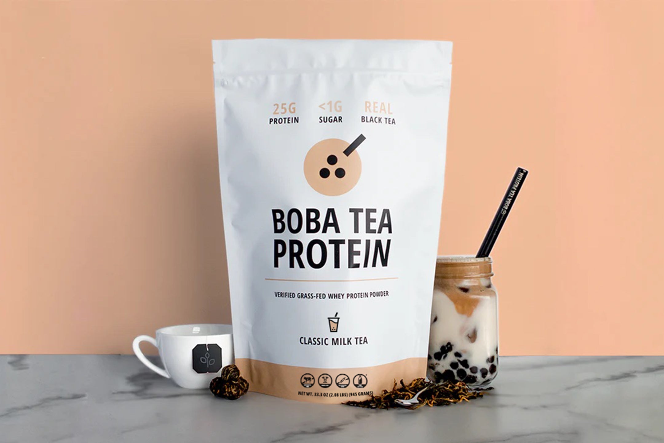 Boba Tea Protein package with a glass of bubble tea on a marble surface.