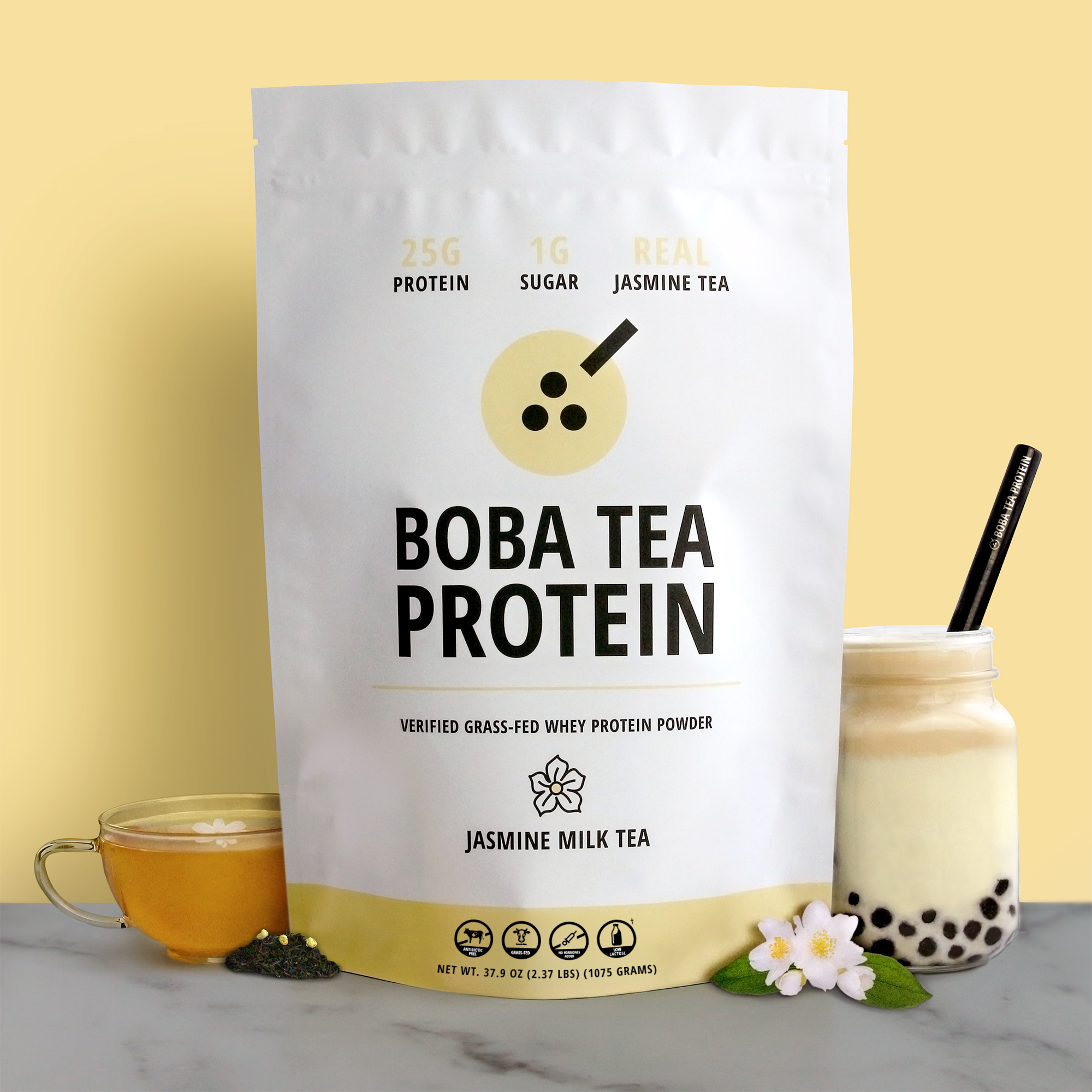 Bag of Boba Tea Protein Jasmine Milk Tea with a cup of tea and boba pearls on a yellow background