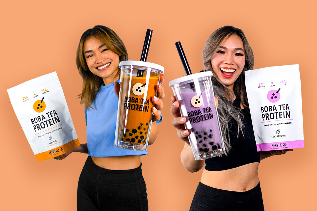 Two women holding Boba Tea Protein drinks and pouches, smiling against an orange background.