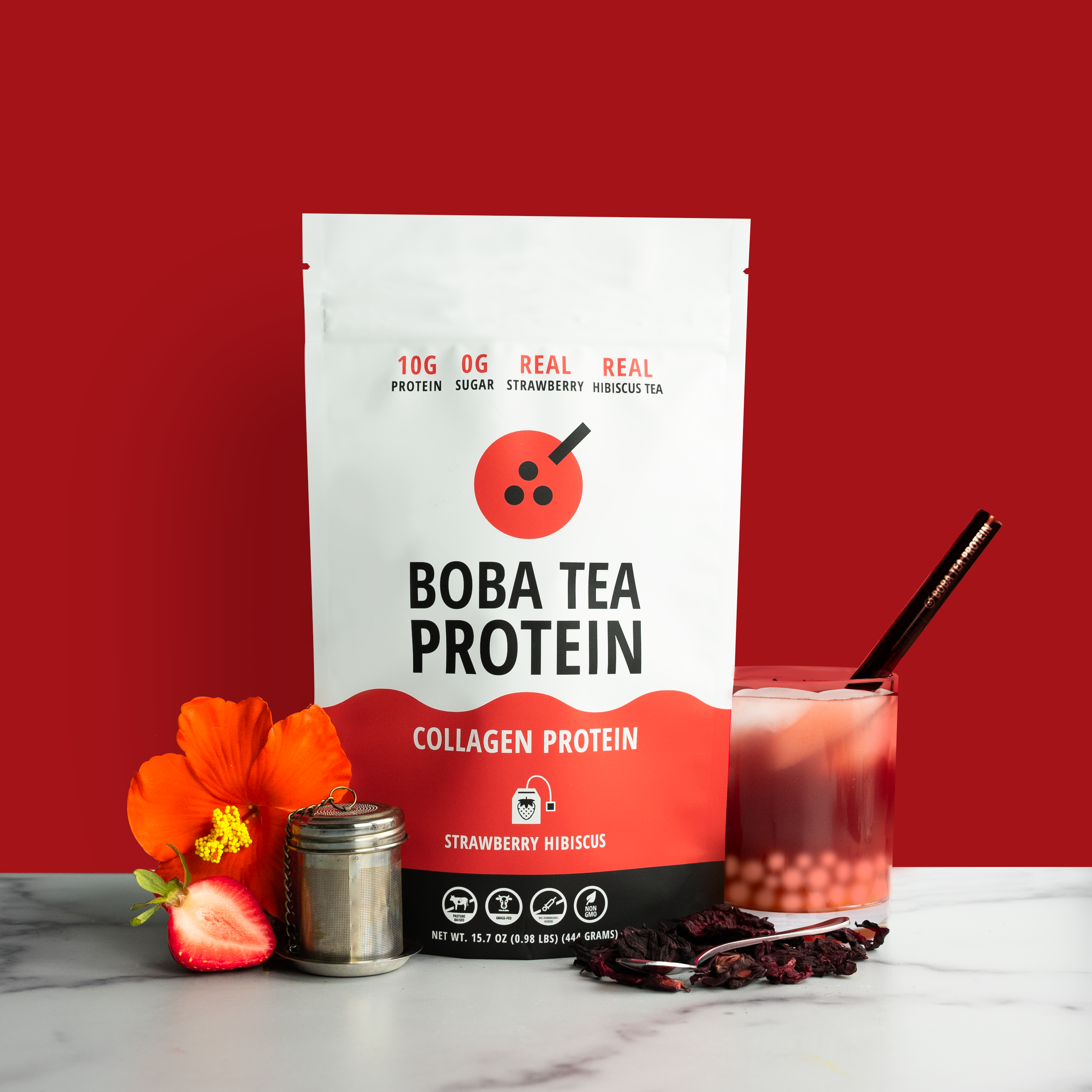 Boba Tea Protein Strawberry Hibiscus pack with hibiscus flower, strawberry, and a glass of strawberry boba tea