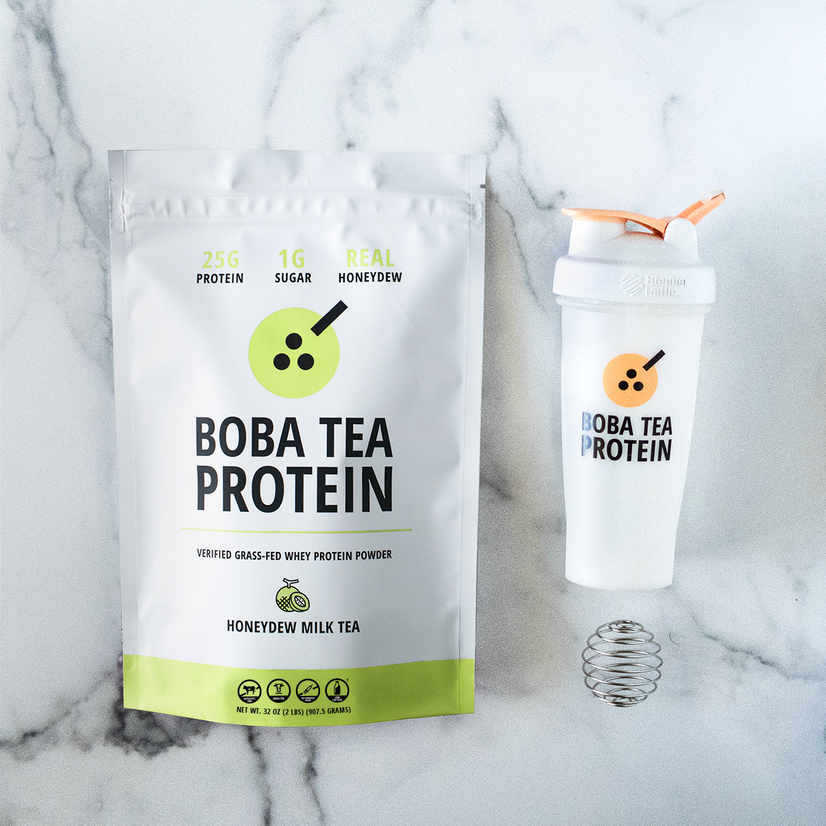 Boba Tea Protein packaging with a shaker bottle on a marble background