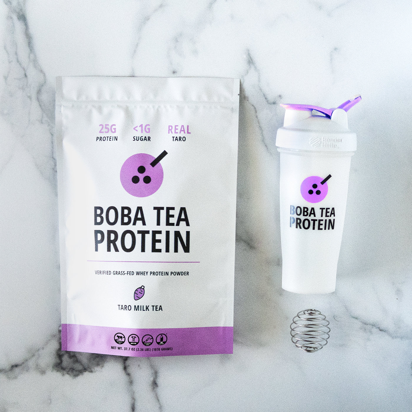 Boba Tea Protein packaging with a shaker bottle on a marble background