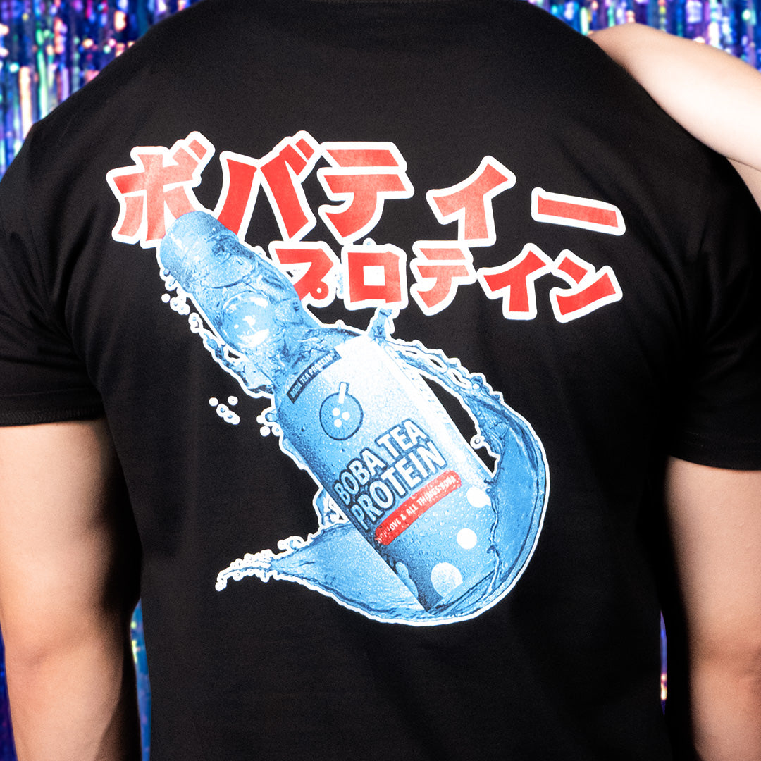 Black t-shirt with a graphic of a soda bottle and Japanese text on the back.